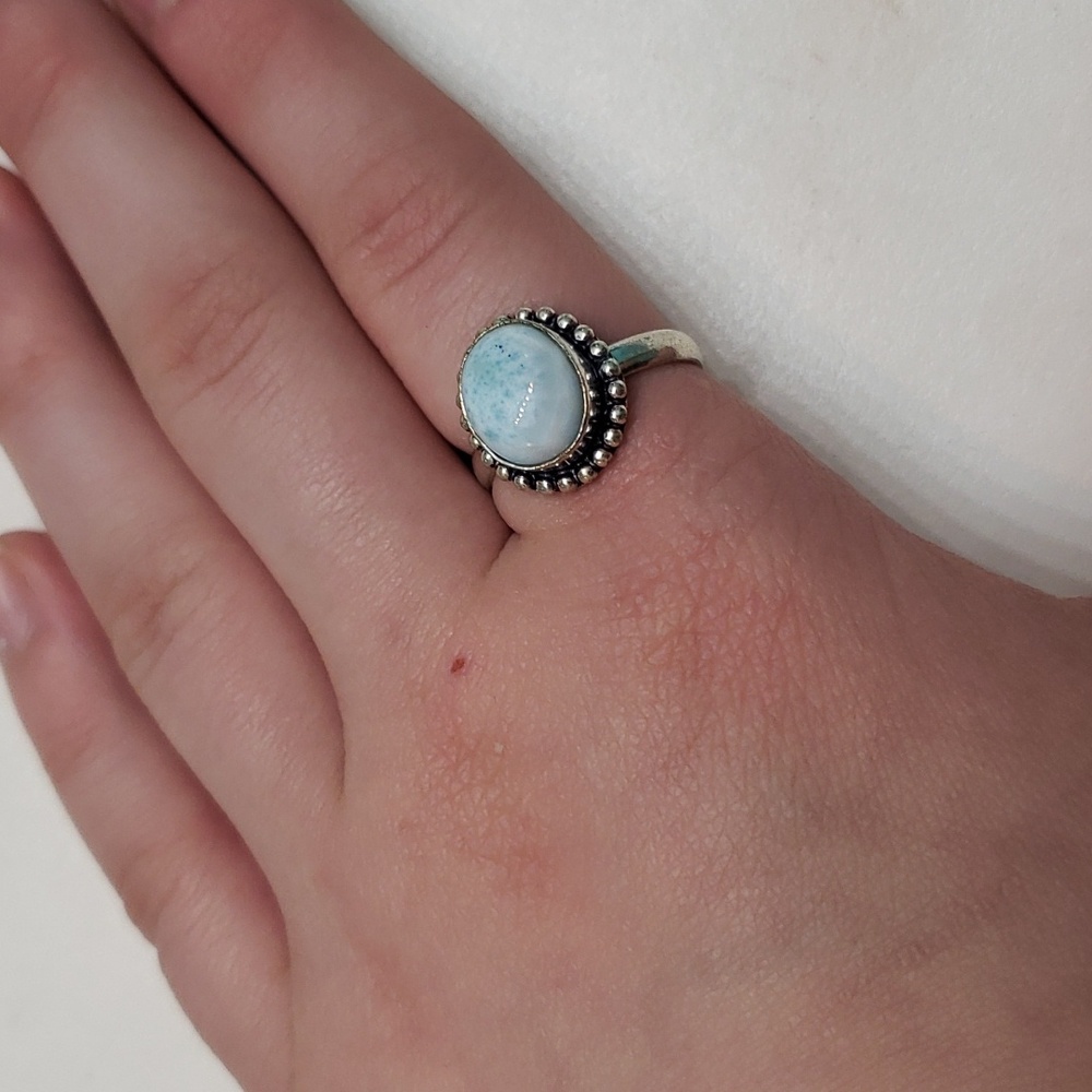 Light blue stone set in silver rind